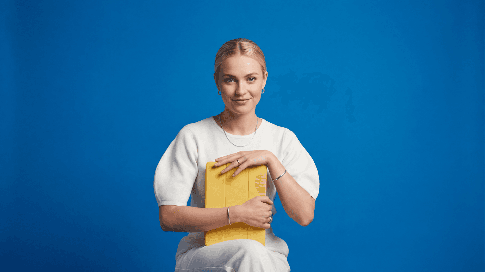 Woman looking at camera holding ipad