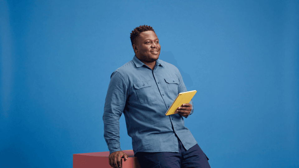 Man smiling standing holding ipad