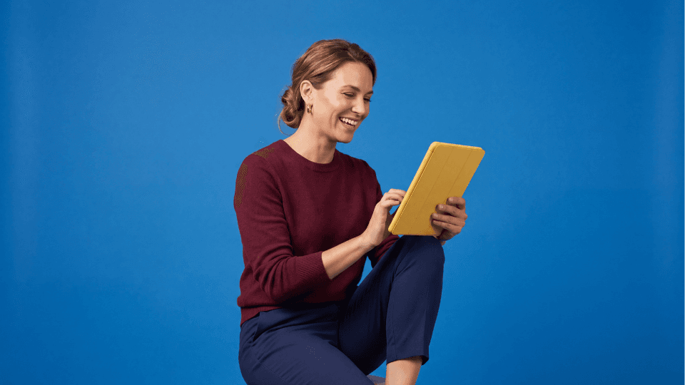 Woman smiling working on ipad